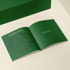 Open square magazine with green elegant design on cubes from studio magazine mockups.