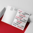 Open a4 magazine with black and red design on red cube from studio magazine mockups.