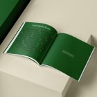 Open square magazine with green elegant design on cubes from studio magazine mockups.