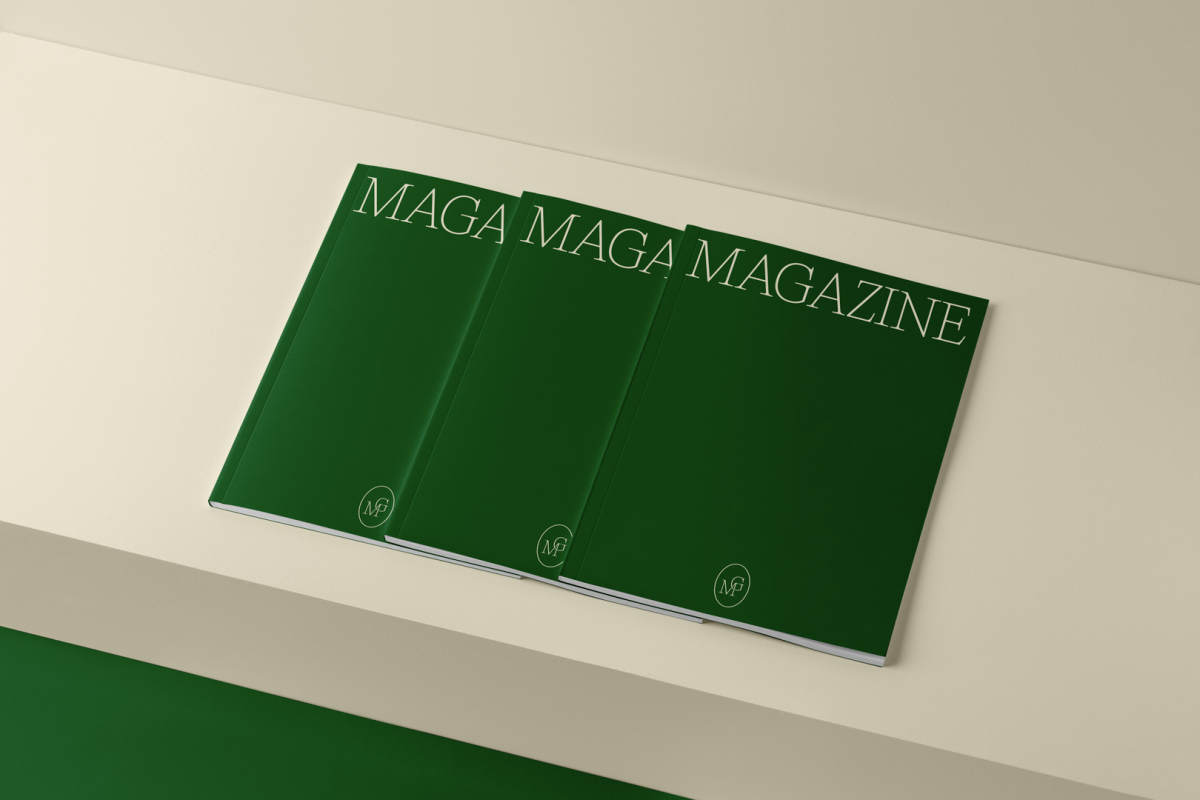 Three a4 green mgazines with elegant design on cubes from studio magazine mockups.