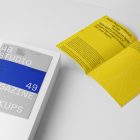 Two a4 gray magazines with minimal design on white stairs from studio magazine mockup.