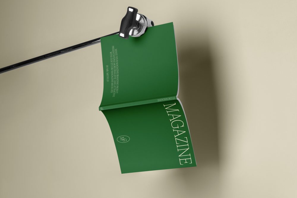 Green magazine cover with elegant design on cube from studio magazine mockups.