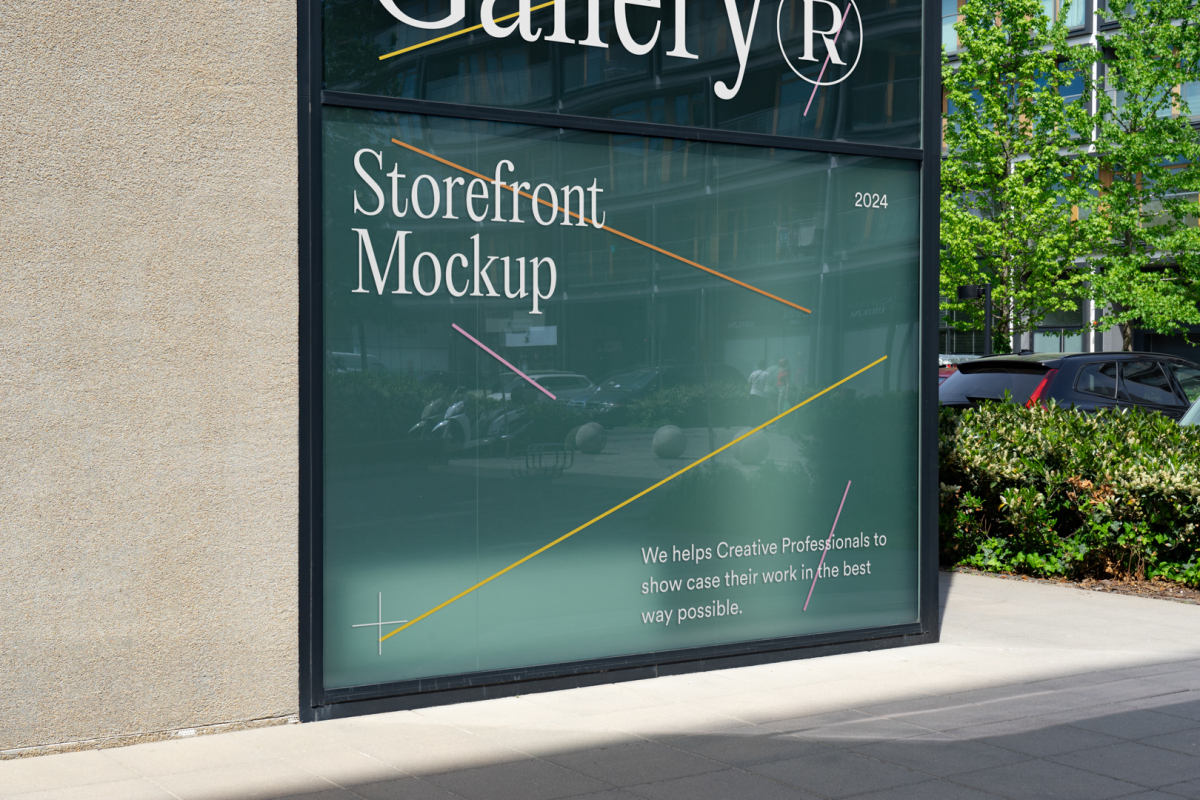 Front view, at an angle of 45 degrees, building corner with colorful graphics and white typography from storefront mockups product with windows where you can see the reflection of city life. Behind the corner are trees, cars, and another building.