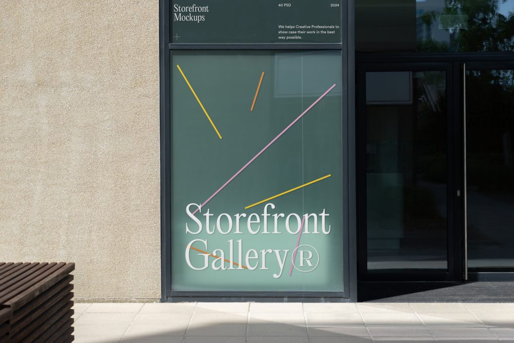 Front view, window with gray frames and colorful graphics and white typography built into the building from storefront mockups product.