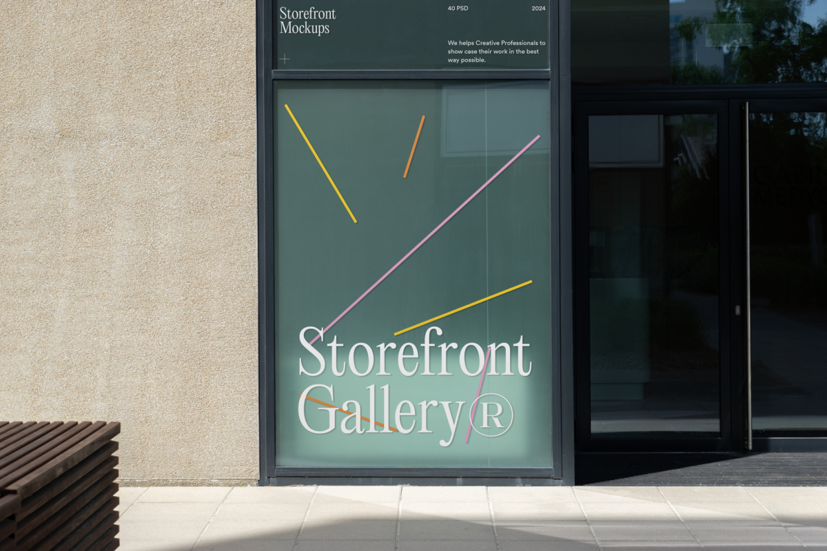 Front view, window with gray frames and colorful graphics and white typography built into the building from storefront mockups product.