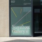 Front view, window with gray frames and colorful graphics and white typography built into the building from storefront mockups product.