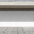Front view, rectangle white space built into a stone beige wall from storefront mockups product.