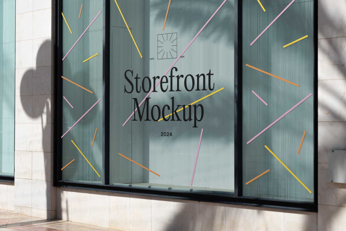 Front view, at an angle of 45 degrees, transparent display window case with colorful graphics and black typography in the building divided into three parts with black frames from storefront mockups product.