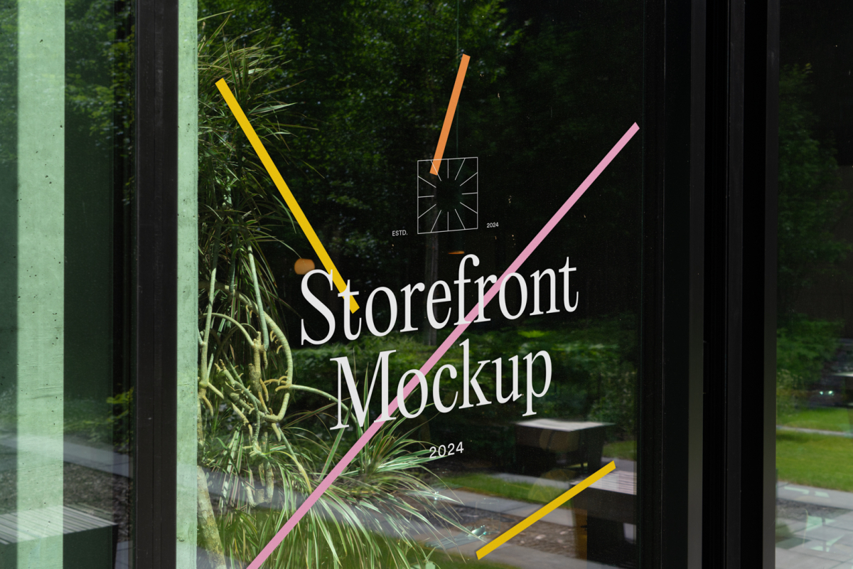 Front view, at an angle of 45 degrees, clean glass window with colorful graphics and white typography from storefront mockups product.