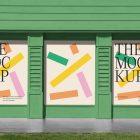 Front view, three colorful rectangle spaces with black typography built into a green building elevation from storefront mockups product.