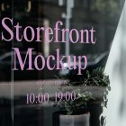 Front view, at an angle of 45 degrees, clean glass window with colorful graphics and pink strong typography from storefront mockups product.