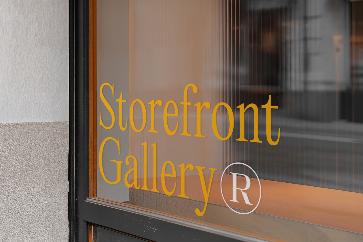 Front view, at an angle of 45 degrees, clean glass window with colorful graphics and orange stong typography from storefront mockups product.