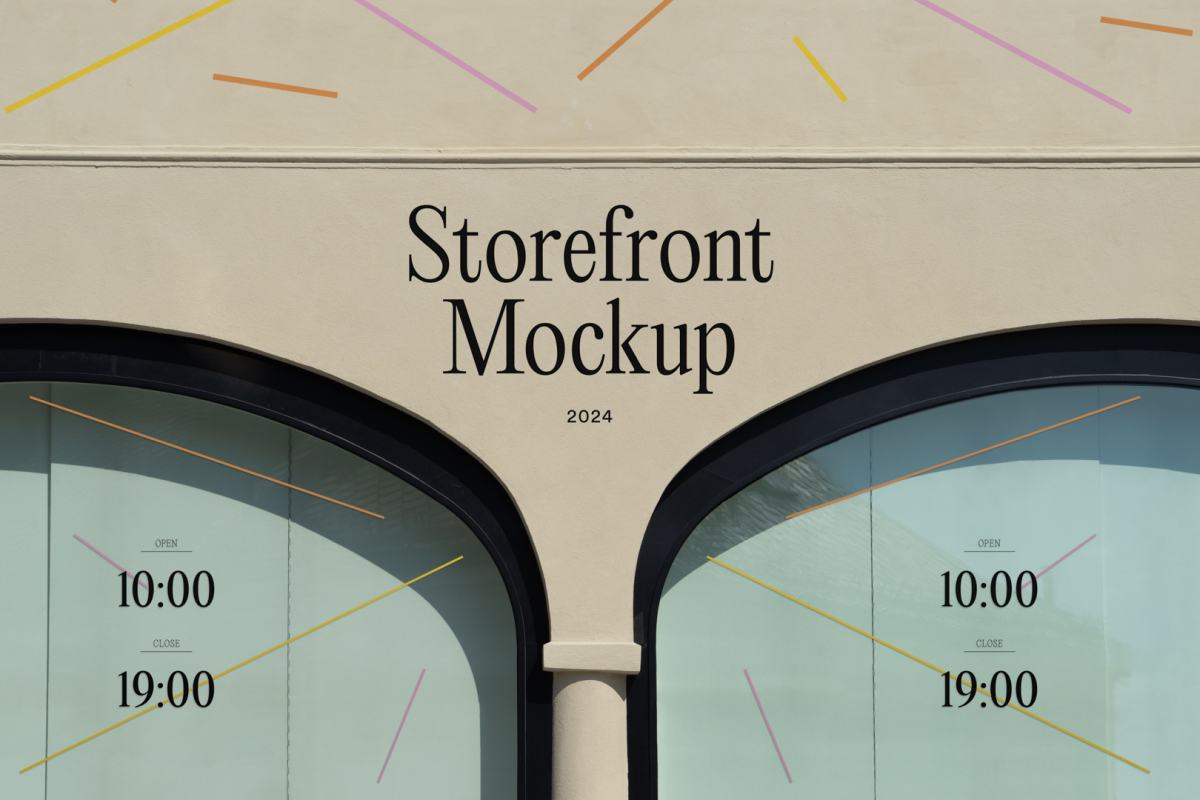 Front view, part of building elevation in beige color with colorful graphics and black typography. Next to two windows with colorful graphics and black typography from storefront mockups product.