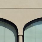Front view, part of building elevation in beige color and two windows from storefront mockups product.