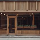 Front view, wooden restaurant facade with transparent windows and door from storefront mockups product.