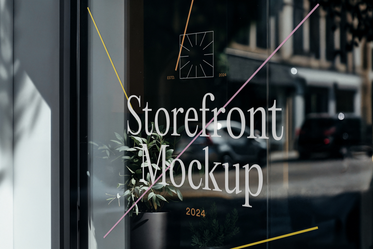 Front view, at an angle of 45 degrees, clean glass window with colorful graphics and white typography from storefront mockups product.