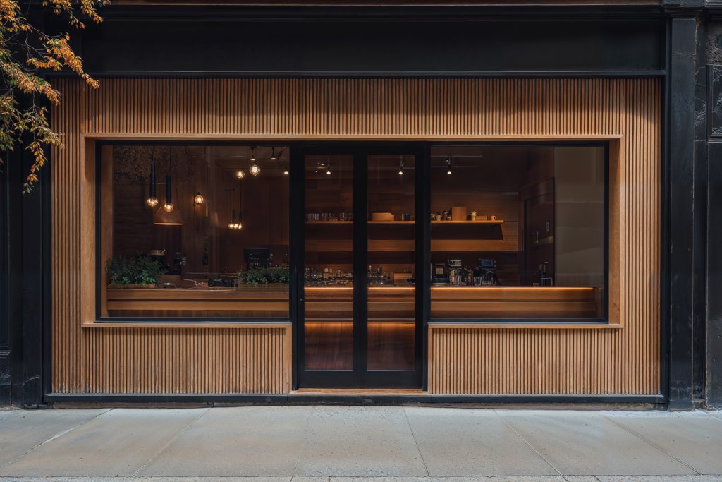 Front view, wooden restaurant facade with transparent windows and door from storefront mockups product.