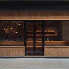 Front view, wooden restaurant facade with transparent windows and door from storefront mockups product.