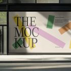 Front view, transparent window with black frames and one big rectangle with colorful graphics and black strong typography space from storefront mockups product.