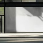 Front view, transparent window with black frames and one big white rectangle space from storefront mockups product.