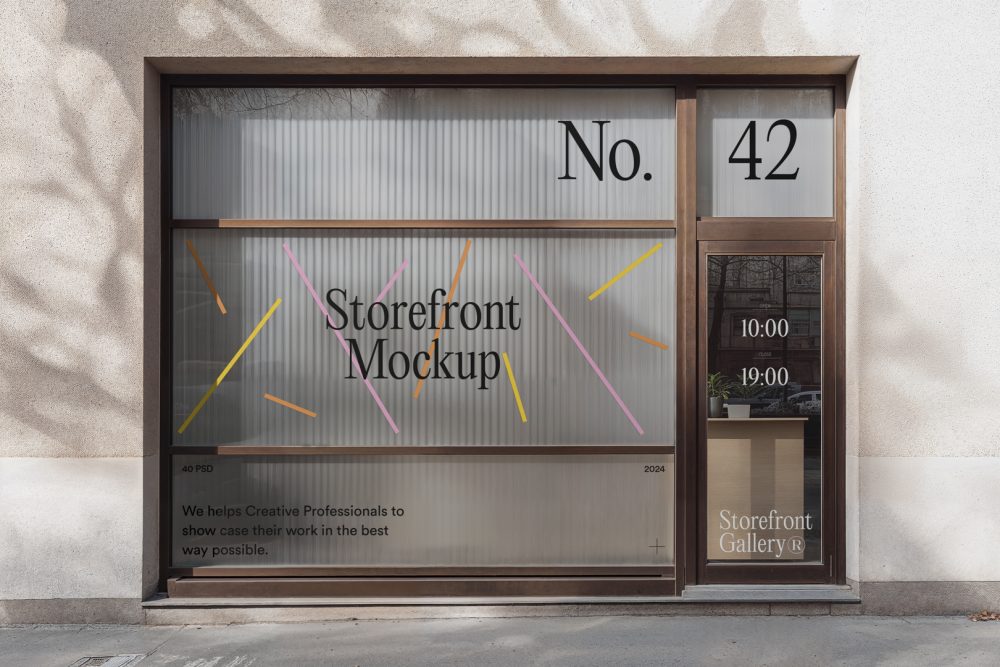 Front view, entrance to the small shop facade with brown frames, five windows with colorful graphics and black strong typography, close glass door from storefront mockups product.