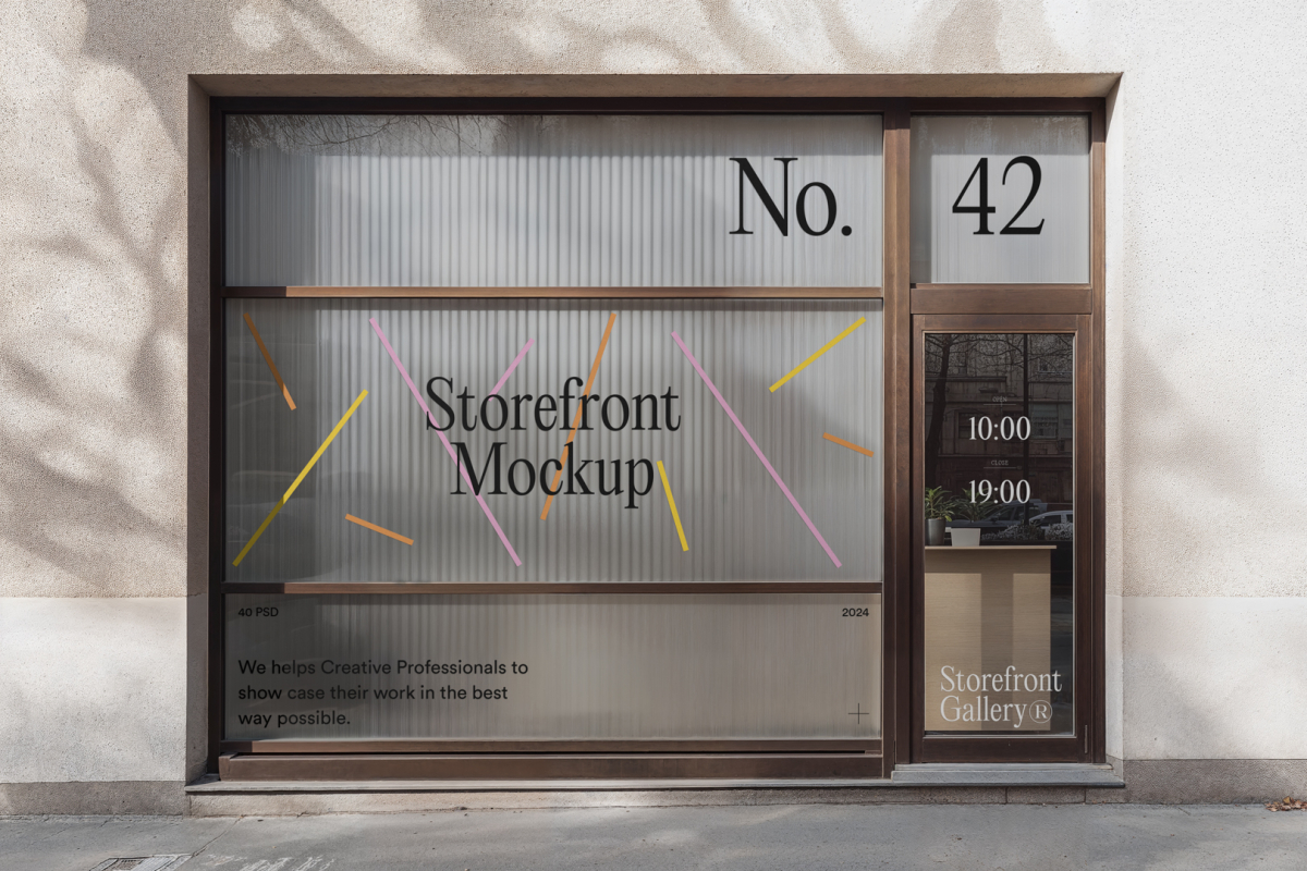 Front view, entrance to the small shop facade with brown frames, five windows with colorful graphics and black strong typography, close glass door from storefront mockups product.