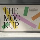 Front view, transparent window with black frames and one big rectangle with colorful graphics and black strong typography space from storefront mockups product.