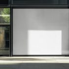 Front view, transparent window with black frames and one big white rectangle space from storefront mockups product.