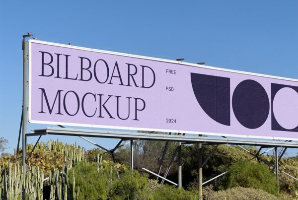 Front view, horizontal billboard mockup with silver frame between trees.