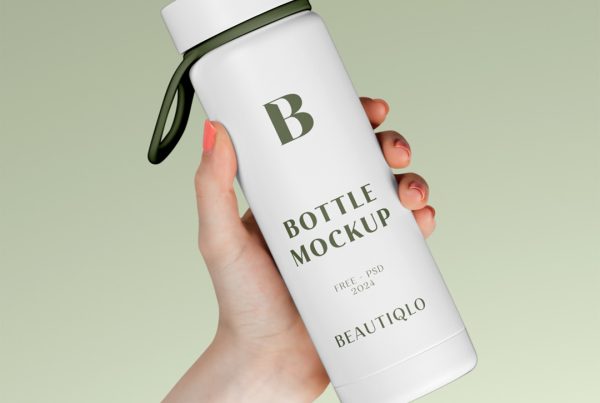 Woman holding a white bottle mockup in hand in front of the green wall.