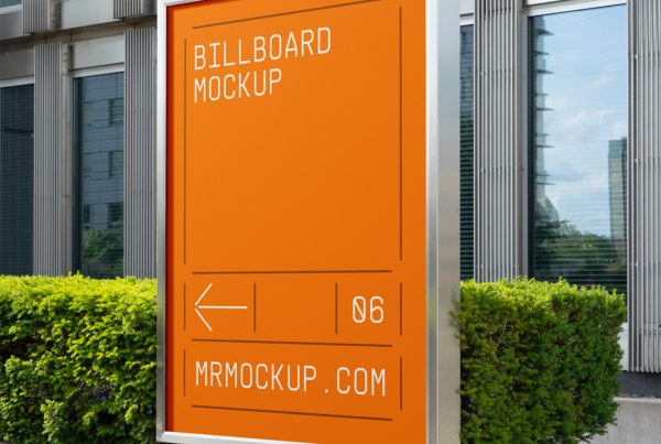 Front view, orange billboard mockup with silver color metal frame attached to the concrete fence in front of the building.