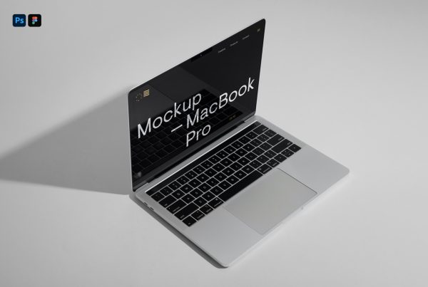 View from above, open silver MacBook Pro Mockup laying on the gray color floor.