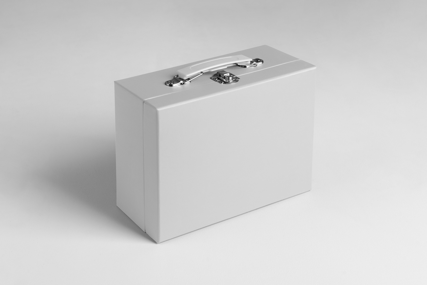 Front view, vintage white suitcase box mockup standing on the white floor.