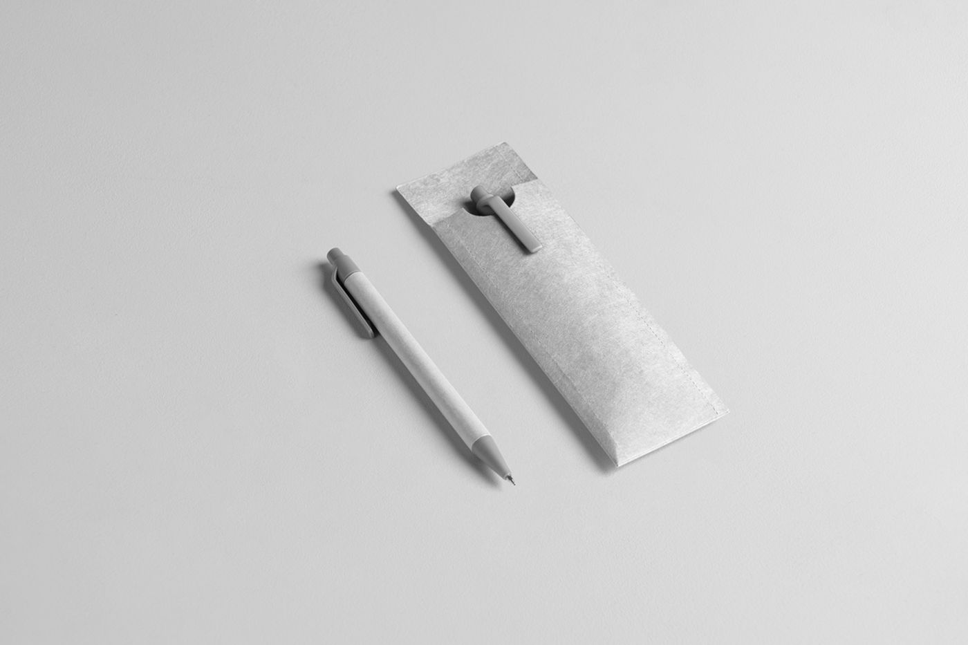 View from above, two white pens with white case mockup laying on the white floor.