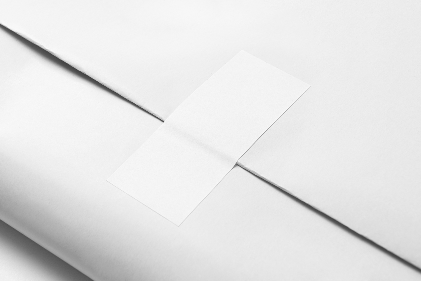 View from above, white wrapping paper mockup with white label on it.