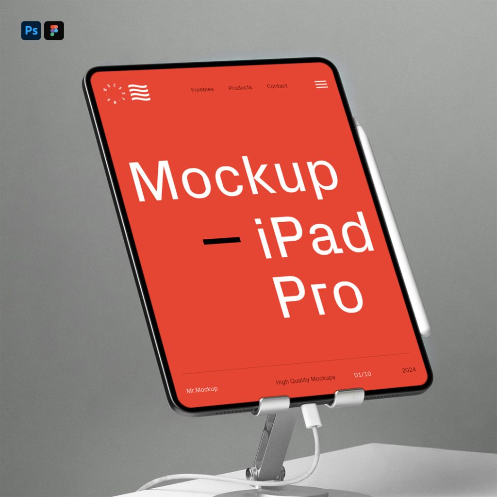 Front view, iPad Pro Mockup attached to the stand on the white table in front of the gray wall.