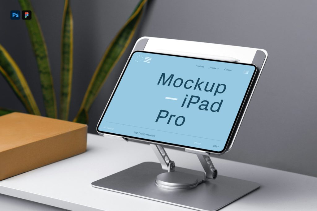 Front view, iPad Pro Mockup attached to the stand on the white table in front of the gray wall.