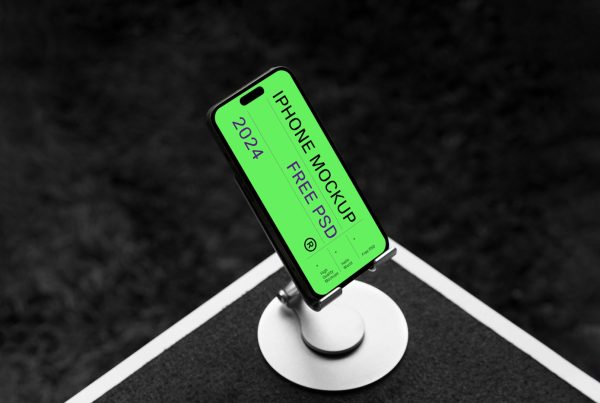 Front view, iPhone Pro Mockup attached to the stand standing on the white table.