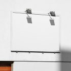 White city billboard mockup with white frames attached to the white building elevation wall.