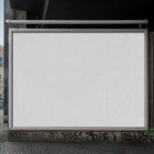 Front view, white city billboard mockup with a silver frames attached to the wall in the middle of the city.