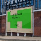 Big horizontal city billboard mockup with green, beige design attached to the brick wall elevation.