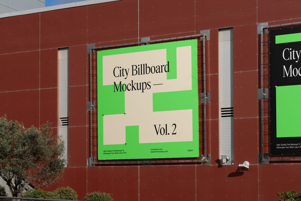 Two square city billboard mockups with a black, green design attached to the red-colored building elevation wall.
