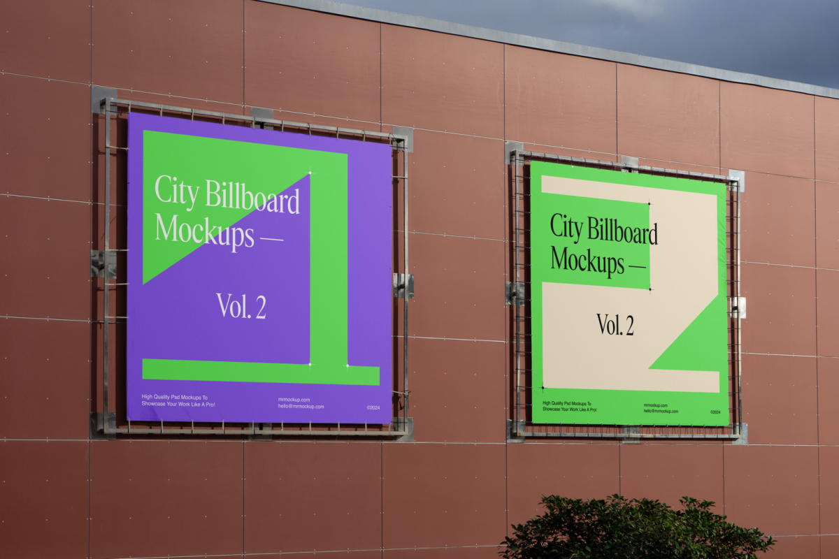 Two square city billboard mockups with a purple, green design attached to the red-colored building elevation wall.