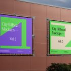 Two square city billboard mockups with a purple, green design attached to the red-colored building elevation wall.