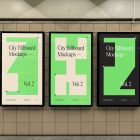 Three vertical city billboard mockups with green, purple, and black design with black frames attached to the beige color wall tiles.