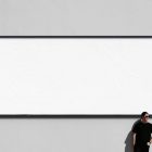 Front view, white horizontal city billboard mockup with black frames attached to the white color wall.