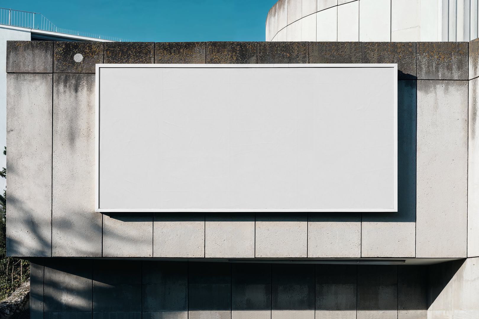 Front view, white horizontal city billboard mockup with white frames attached to the concrete building facade.