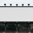 Front view, white city billboard mockup with strong black metal frames standing for city bridge.