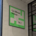 Square city billboard mockup with bright beige, green design and black frames attached to the beige building facade.