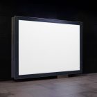 Horizontal white city billboard mockup attached to the black marble wall.